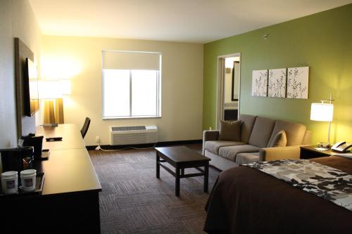 a hotel room with a bed and a living room at Sleep Inn Ellenboro Hwy 50 in Ellenboro