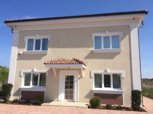 a house with two windows and a roof at Armonia Apartments in Timişoara