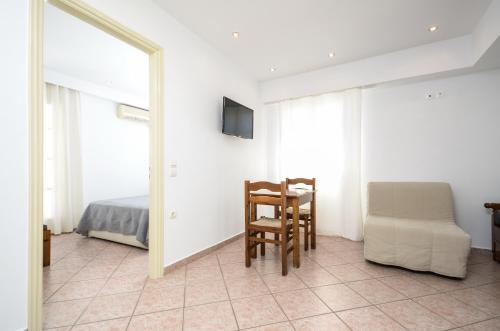 a bedroom with a table and a chair and a mirror at Windmill Naxos in Naxos Chora