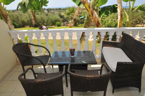 a table and chairs on a balcony with a view at Ionion Star Hotel in Tholón