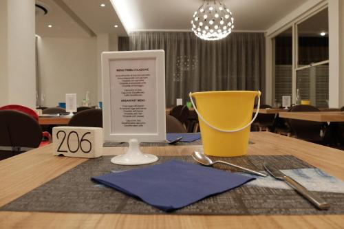 a table with a menu on top of a table at Hotel Aurea in Rimini