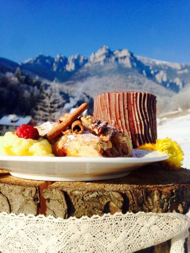 a plate of food sitting on top of a table at Pensiunea Bia Papadia in Bicaz