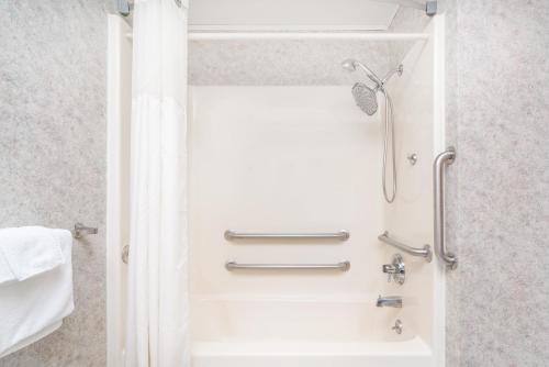 a shower in a bathroom with a shower curtain at Days Inn by Wyndham Hurley in Hurley