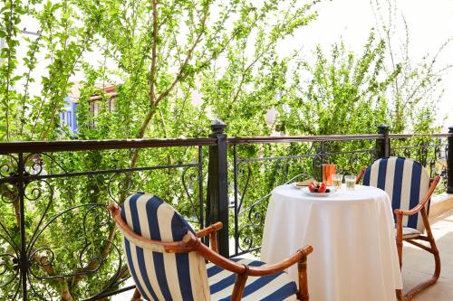two chairs and a table on a balcony at Archodiko Toliadi Boutique Apartments and Suites in Ouranoupoli