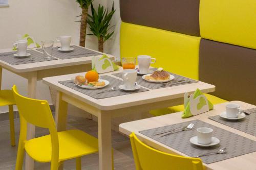 two tables and chairs with plates of food on them at NicaDomus B&B in Licata