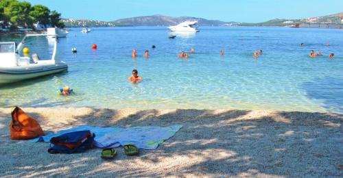 a group of people in the water at a beach at Villa Anastasia in Trogir