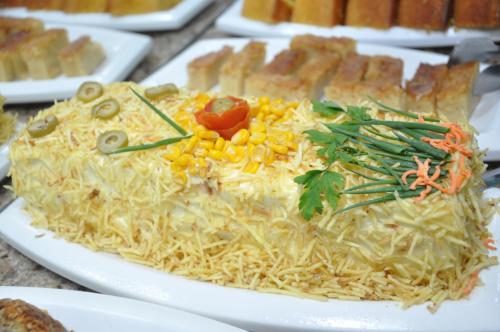 a plate of food with noodles and vegetables on it at Bonjour Hotel in Macaé