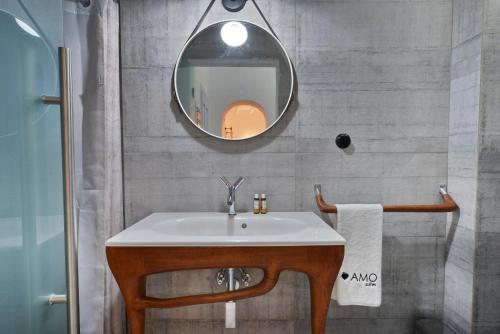 a bathroom with a sink and a mirror at AMO Folegandros in Karavostasi