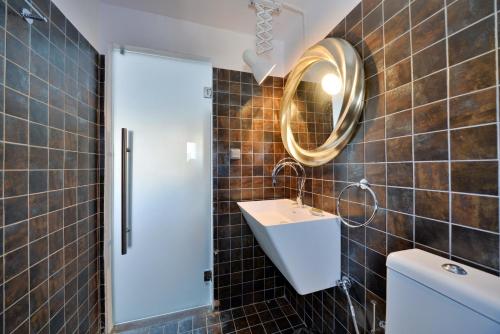 a bathroom with a sink and a mirror at AMO Folegandros in Karavostasi