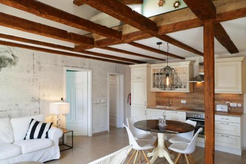 a kitchen and living room with a table and chairs at Bellavista Attic Apartment in Izola
