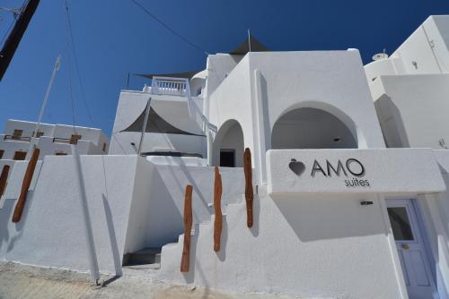 a white building with a sign on it at AMO Folegandros in Karavostasi