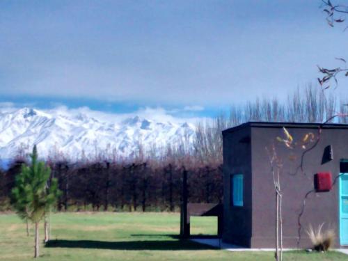 a building with a view of a snow covered mountain at Finca La Clementina in Tunuyán