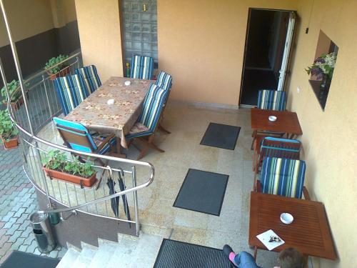 a room with a table and chairs and a shopping cart at Pensiunea Select in Arad
