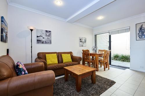 a living room with a couch and a table at Fremantle Townhouse u/5 in Fremantle