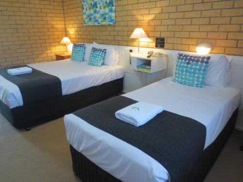 מיטה או מיטות בחדר ב-Aspley Pioneer Motel