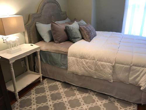 a bedroom with a bed with a side table and a lamp at Vineyard Mansion Carriage House in Saint Joseph