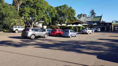 a parking lot filled with cars and motorcycles at Royal Hotel Singleton in Singleton