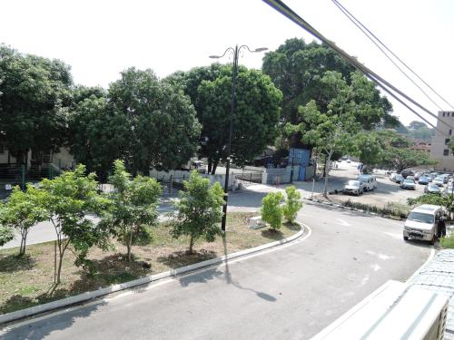 a view of a street with trees and cars on the road at The Pillohouzzze in Melaka