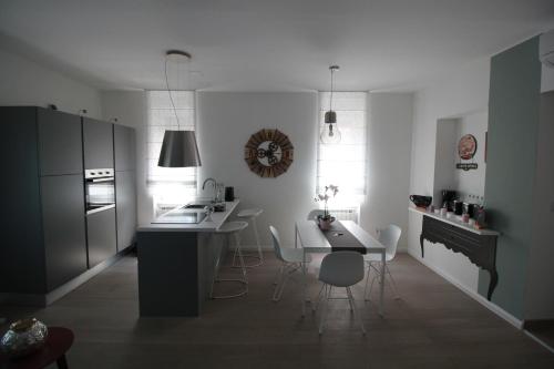 a kitchen with a table and chairs and a kitchen with a stove at Apartman Stoosova Deluxe in Zagreb