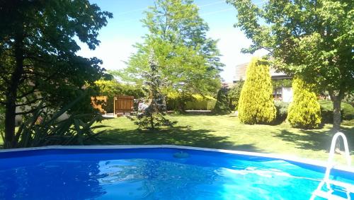 a swimming pool in a yard with trees at Los Arces in Elosu