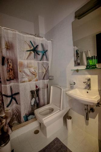 a bathroom with a toilet and a sink at Domna Studios in Lindos
