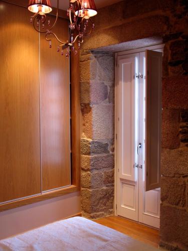 a room with a door and a stone wall at Hotel Casa de Caldelas in Castro Caldelas