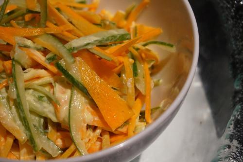 a bowl of food with carrots and green onions at Luminor Hotel Jambi Kebun Jeruk By WH in Jambi