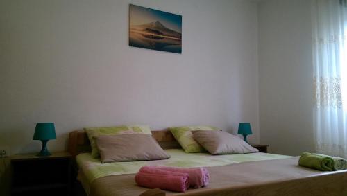 a bedroom with two beds with pillows on them at Apartmani Ledenko in Kaštela