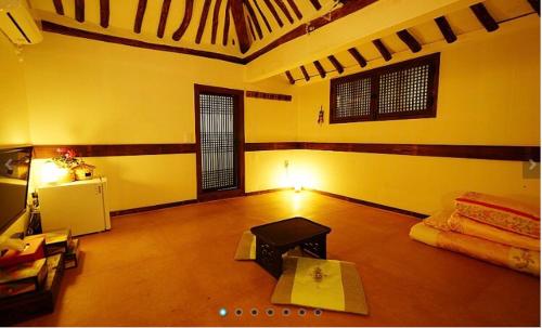 a room with a living room with a table in it at Gohyundang in Jeonju
