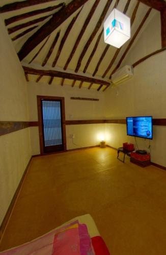 a living room with a large room with a flat screen tv at Gohyundang in Jeonju