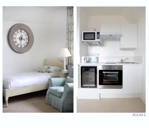 a room with a kitchen with a stove and a bed at The Old Stables in Minehead