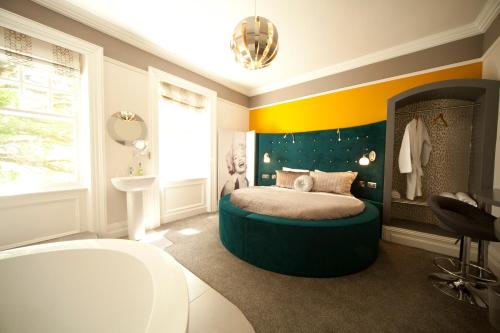 a bedroom with a bed and a tub in it at Kilmore Country House in Glenariff
