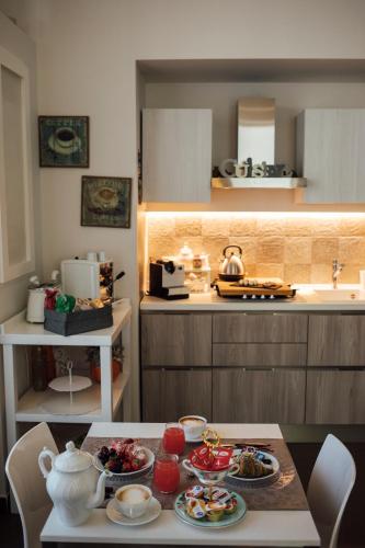 a kitchen with a table with plates of food on it at Gran Cancelliere B&B in Palermo