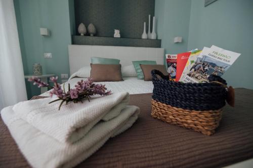 a bedroom with a bed with towels and a basket at Gran Cancelliere B&B in Palermo