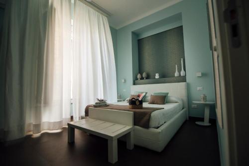 a bedroom with a bed and a table and a window at Gran Cancelliere B&B in Palermo