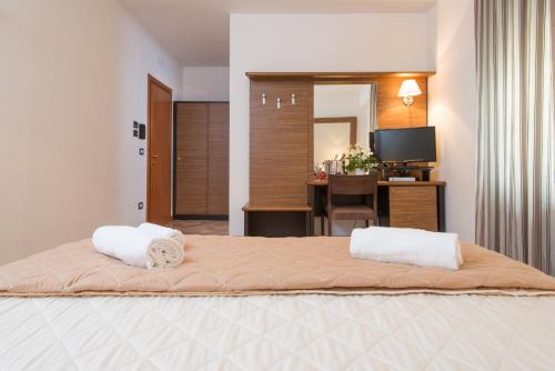 a bedroom with a bed with two towels on it at Royal Hotel in Cosenza