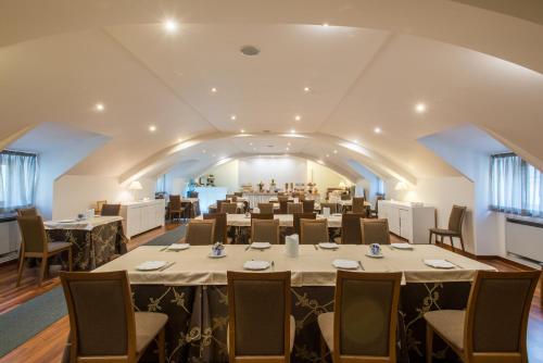 a banquet hall with tables and chairs in a room at Royal Hotel in Cosenza