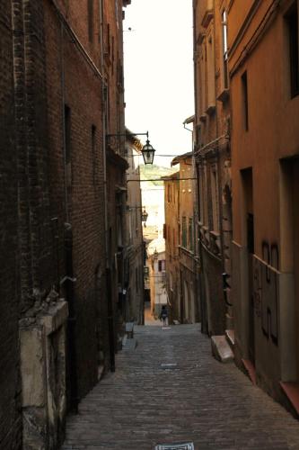 an alley with a person walking down a street at B&B Da Zia Ore in Iesi