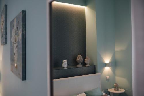 a mirror in a room with a bed and a table at Gran Cancelliere B&B in Palermo