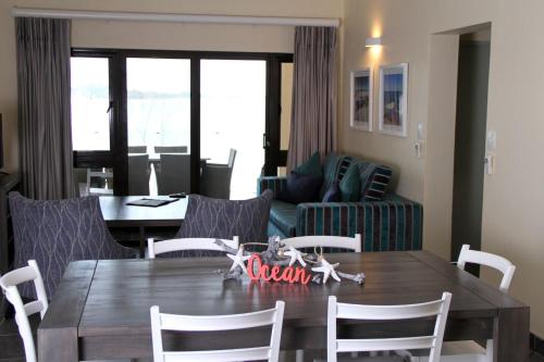 a dining room with a wooden table and chairs at Bilene Lodge by Dream Resorts in Vila Praia Do Bilene