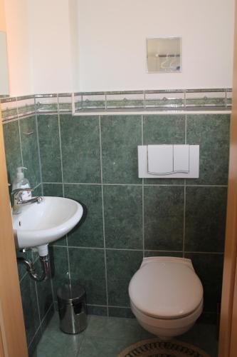 a bathroom with a toilet and a sink at Seaside Villa Leipzig in Leipzig