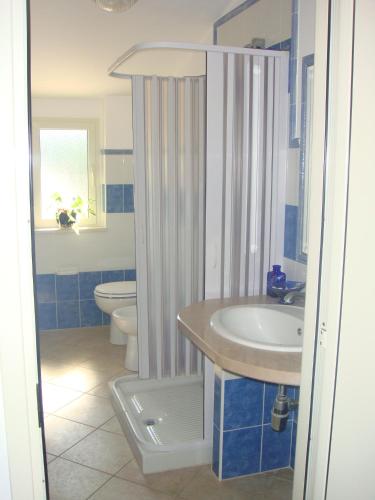 a bathroom with a sink and a toilet at Residence e B&B La Cappella Del Convento in Rodi Garganico