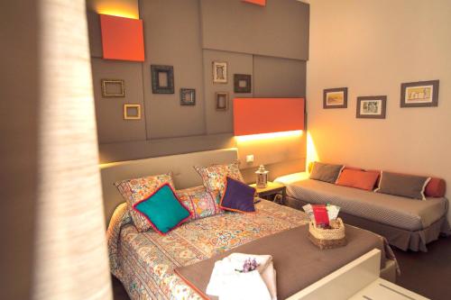 a living room with a bed and a couch at Gran Cancelliere B&B in Palermo