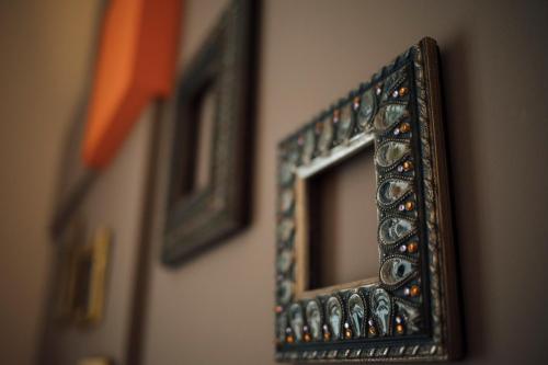 a mirror on a wall with pictures on it at Gran Cancelliere B&B in Palermo