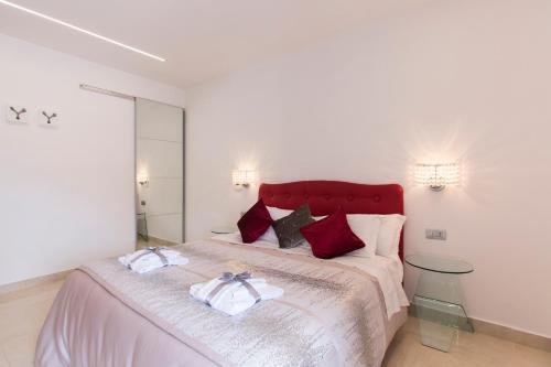 a bedroom with a large bed with two towels on it at San Pietro Grand Suite in Rome