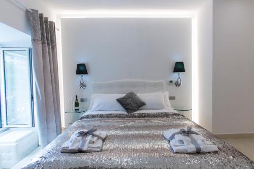 a bedroom with a large bed with two towels on it at San Pietro Grand Suite in Rome