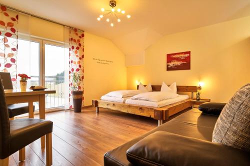 a bedroom with a bed and a large window at Gasthof-Pension Boxleitenmühle in Waldkirchen