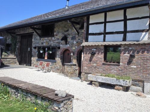 a brick building with a bench in front of it at B&B Chambre d'hôtes de la Vecquée in Stoumont
