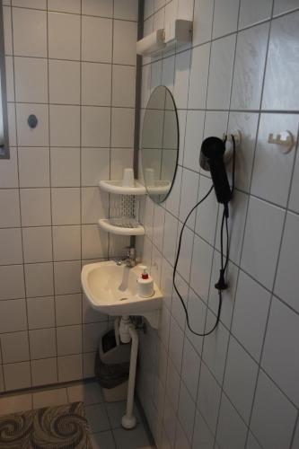 a bathroom with a sink and a mirror on the wall at Villa Marleen in Pärnu