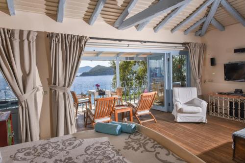 a living room with a view of the water at Beyaz Yunus Hotel - Adult Only in Oludeniz